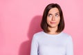 Photo of doubtful uncertain young lady dressed white jumper looking empty space thinking about vaccination isolated pink