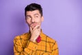 Photo of doubtful uncertain young man wear plaid shirt bow tie arm chin looking empty space isolated violet color