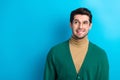 Photo of doubtful unsure man wear green cardigan spectacles biting lip looking empty space isolated blue color Royalty Free Stock Photo