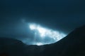 Photo of dramatic rays of light pushing up through clouds Royalty Free Stock Photo