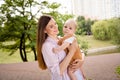 Photo of dreamy adorable mother small daughter wear casual outfits smiling walking outside garden