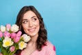 Photo of dreamy adorable woman wear pink cardigan holding bunch looking emtpy space isolated blue color background Royalty Free Stock Photo