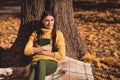 Photo of dreamy calm peaceful girl forest countryside tourist sit under fall lawn park maple leaves tree checkered Royalty Free Stock Photo