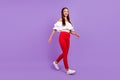 Photo of dreamy carefree lady enjoy walk stroll wear white blouse pants shoes isolated violet color background