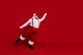 Photo of dreamy carefree old man hold imaginary umbrella wear santa hat suspenders isolated red color background