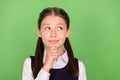 Photo of dreamy charming school girl dressed formal clothes arm chin looking empty space green color background