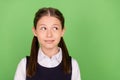 Photo of dreamy charming schoolgirl wear formal outfit smiling looking empty space green color background