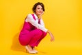 Photo of dreamy charming young woman dressed pink suit sitting arm cheek empty space smiling isolated yellow color