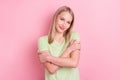 Photo of dreamy cheerful cute lovely lady embrace shoulders wear green t-shirt isolated on pink background