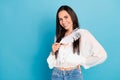 Photo of dreamy cheerful girl dressed white blouse holding soft feather empty space isolated blue color background