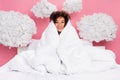 Photo of dreamy cheerful lady wear pajama sitting bed cover blanket feeling cold clouds isolated pink color background