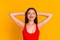 Photo of dreamy cute lady dressed bodysuit closed eyes arms behind head yellow color background