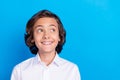 Photo of dreamy cute school boy wear formal outfit smiling looking empty space blue color background