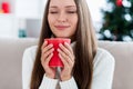 Photo of dreamy happy young woman hold hands mug coffee smell xmas indoors inside house home apartment Royalty Free Stock Photo