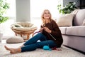 Photo of dreamy lovely senior lady knitting warm pullover enjoying weekend hobby time indoors Royalty Free Stock Photo