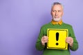 Photo of dreamy man pensioner dressed green pullover holding hazard card empty space isolated purple color background