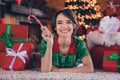 Photo of dreamy sweet young lady wear elf clothes lying floor holding lollipop smiling indoors house home room Royalty Free Stock Photo