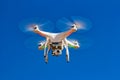 Drone with camera flying with blue sky in the background Royalty Free Stock Photo