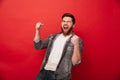 Photo of ecstatic cheerful man 30s in jeans jacket yelling in de Royalty Free Stock Photo