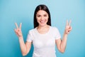 Photo of ecstatic encouraged kind cheerful cute woman showing you double v-sign while isolated with blue background