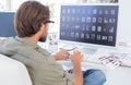 Photo editor looking at thumbnails on computer Royalty Free Stock Photo