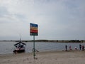 Photo Editorial, 20 Januari 2021, North Jakarta, Indonesia life Guard Tower, Warning Sign at Beach with some tourist