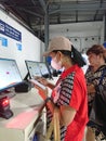 Photo editorial, 07 november, 2 woman doing ticket printing at yogyakarta yogya, jogja, jogjakarta, indonesia train station
