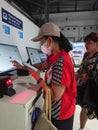 Photo editorial, 07 november, 2 woman doing ticket printing at yogyakarta yogya, jogja, jogjakarta, indonesia train station