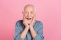 Photo of elder white hairdo man hands face wear blue shirt isolated on pink color background Royalty Free Stock Photo