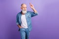 Photo of elderly man happy positive smile show fingers hello salute look empty space isolated over purple color