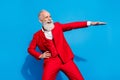 Photo of elederly handsome man happy positive smile have fun cool dance wear suit isolated over blue color background