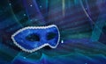 Photo of elegant and delicate Venetian mask over blue dark chiffon background