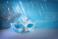 Photo of elegant and delicate Venetian mask over white and blue background. Carnival masquarede and christmas concept Royalty Free Stock Photo