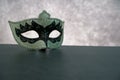 Photo of elegant white and black venetian, carnaval mask over dark background. Vintage photo