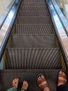 Photo of an elevator moving down with the appearance of the legs of a father and his son