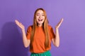 Photo of emotional girl red hair model raised arms demonstrating great event announcement up head isolated on violet Royalty Free Stock Photo