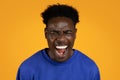 Photo of emotional screaming young black man on yellow Royalty Free Stock Photo