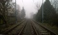 Empty railroad tracks partially covered in fog Royalty Free Stock Photo