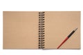 Photo of an empty, unfolded notebook on a spiral, with sheets of Kraft paper and a pen on a white isolated background