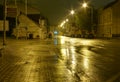 Empty wet street at night illuminated by lamps Royalty Free Stock Photo