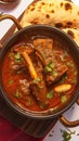 Photo Enjoy the rich flavors of Lamb Rogan Josh with Naan.