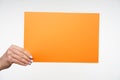 Photo of envelope A4 format with important documents being passed by elegant young woman`s hand to someone, isolated against whit