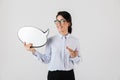 Photo of european female worker wearing eyeglasses holding blank thought bubble, isolated over white background