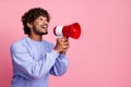 Photo of excited cheerful guy wear trendy clothes hold bullhorn tell say proclaim news isolated on pink color background