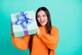 Photo of excited crazy lady hold gift box open mouth wear orange pullover isolated turquoise color background Royalty Free Stock Photo