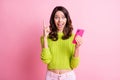 Photo of excited creative girl hold telephone open mouth direct finger wear green pullover isolated pink color