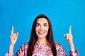 Photo of excited dreamy lady dressed print blouse looking pointing two fingers up emtpy space isolated blue color Royalty Free Stock Photo