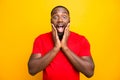 Photo of excited ecstatic rejoicing overjoyed black man admiring something adoring while isolated with yellow background