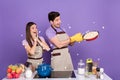 Photo of excited funky boyfriend girlfriend dressed chef outfit cooked tasty movie snack isolated purple color