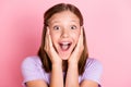 Photo of excited happy cheerful young girl hold hands cheekbones isolated on pastel pink color background